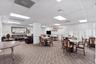 Fitness center featuring rubberized flooring, drop ceiling with recessed lighting, structural support columns, and full-length mirrored walls