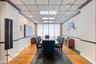 Common area featuring a built-in stone-top bar, integrated tiered shelving, drop ceiling with recessed lighting, and expansive interior shutters
