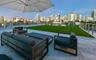 Rooftop terrace featuring concrete flooring, artificial turf, and stainless steel cable railing