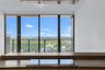 Floor-to-ceiling windows, integrated cooktop, stone-surface countertop, and exterior balcony railing