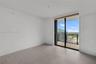 Interior space featuring wood-finish flooring, floor-to-ceiling glass sliding doors, and a private balcony with metal railing