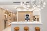 Living area featuring floor-to-ceiling glass sliding doors, textured accent wall, built-in cabinetry with integrated shelving, recessed ceiling lighti