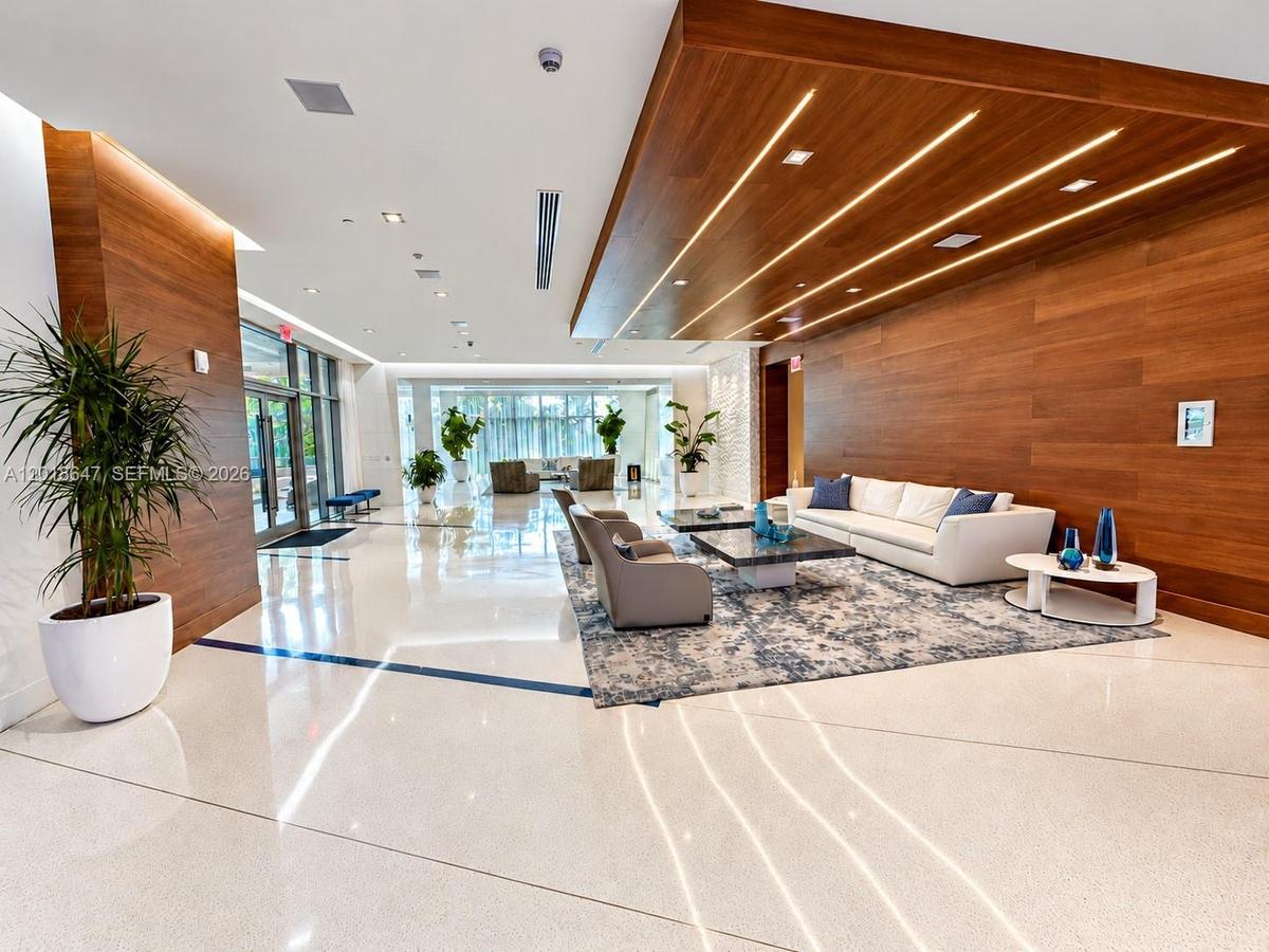 Floor-to-ceiling glass sliding doors, built-in wooden cabinetry, recessed ceiling lighting, and hard surface flooring