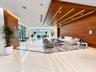 Floor-to-ceiling glass sliding doors, built-in wooden cabinetry, recessed ceiling lighting, and hard surface flooring