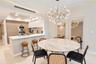 Floor-to-ceiling glass sliding doors, recessed lighting, textured wall paneling, and an expansive balcony with metal railing