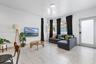 Living space featuring large-format tile flooring, a recessed bay window, flush-mount ceiling lighting, and a glass-paneled exterior door