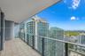 Private balcony featuring square tile flooring and a glass-paneled railing