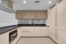 Kitchen featuring flat-panel cabinetry, stainless steel backsplash, integrated refrigerator, built-in wall oven, and recessed ceiling lighting