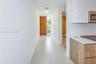 Entryway featuring a solid wood door, large-format tile flooring, and clean-lined cabinetry with a matte finish