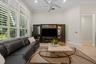 High ceilings with recessed lighting, integrated ceiling fan, plantation shutters, and large-format tile flooring