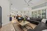 Open-concept interior featuring high ceilings, stone-finish tile flooring, recessed lighting, a multi-blade ceiling fan, and large windows with planta