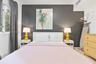 Neutral-toned room featuring a dark charcoal accent wall, horizontal slat window blinds, and tile flooring