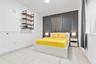 Room featuring large-format tile flooring, a dark charcoal accent wall, and wall-mounted industrial-style shelving with wood-finish surfaces and black