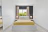 Bedroom interior featuring large-format tile flooring, a dark charcoal accent wall, a central window, and an integrated floor-to-ceiling mirror