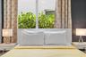 Large window with natural light, white integrated headboard, and dual built-in bedside surfaces
