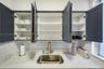 Shaker-style cabinetry with matte finish, white subway tile backsplash, solid-surface countertop, stainless steel undermount sink, and brass-finish go