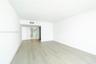Interior space featuring light-toned wood-finish flooring, smooth white walls, and solid-core interior doors