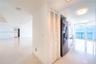 Interior space featuring polished stone flooring, recessed lighting, white louvered closet doors, stainless steel refrigerator, and floor-to-ceiling w