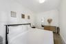 Neutral walls, wood-finish flooring, and recessed ceiling lighting