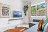 Large horizontal window, stone-finish flooring, and built-in floating wooden shelf