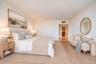 Light-filled interior featuring wide-plank wood-finish flooring and smooth finish walls