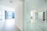 Floor-to-ceiling glass sliding doors, private balcony, large-format tile flooring, and mirrored sliding closet doors