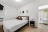 Wood-finish flooring, white walls, and built-in metal shelving
