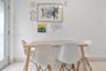 Light-toned stone-finish flooring and full-height glass door panel