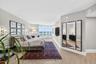 Wood look plank porcelain flooring, floor-to-ceiling bay windows, and a multi-panel mirror dressing area. This is said to be the only unit in the buil