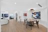 Open-concept dining nook area (can also be a space for an office) featuring porcelain flooring, recessed lighting, and a modern beautiful tiered-orb f