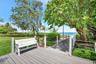 Elevated composite decking leads to mature coastal landscaping, and a direct path to the sandy oceanfront