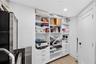 One angle of the walk in closet off bedroom #3 w/ custom built ins. Closet is very large wraps around into a large L shape