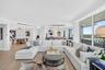 Open-concept floor plan featuring wood look plank porcelain flooring, floor-to-ceiling glass doors, recessed lighting, and a built in buffet behind th