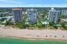 High-rise building featuring direct beachfront access, exterior balconies, and landscaped grounds