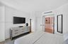Bright interior space featuring neutral walls, wood look plank porcelain flooring, double-panel interior doors
