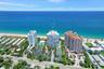 Aerial view of Corniche - beachfront high-rise featuring direct ocean frontage, on-site tennis court, swimming pool, and landscaped grounds