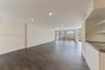 Open-concept interior featuring wood-finish flooring, recessed lighting, floor-to-ceiling glass sliding doors, private balcony, and built-in cabinetry