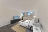 Neutral-toned room featuring expansive floor-to-ceiling windows and wood-finish flooring