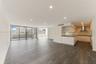 Open floor plan featuring wood-finish flooring, recessed lighting, floor-to-ceiling glass doors, and a kitchen equipped with cabinetry, stone-surface 