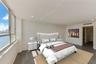 Floor-to-ceiling windows, wood-finish flooring, recessed lighting, and wall-mounted climate control unit