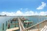 Waterfront dock featuring multiple boat slips, composite decking, and a metal railing system