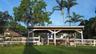 Open-air wood pavilion featuring a post-and-beam structure with an attached split-rail fence and mature palm trees