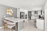 Kitchen featuring white shaker-style cabinetry, quartz countertops, stainless steel appliances, recessed lighting, and large-format porcelain tile flo