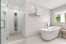 Freestanding soaking tub with a floor-mounted faucet, walk-in shower featuring textured wall tile, stainless steel rainfall shower panel, and pebble-s