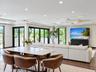 Open-concept living space featuring wood-finish flooring, recessed lighting, and expansive glass sliding doors