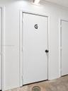 Smooth-finish white interior doors featuring matte black round door knobs and casing trim