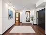 Interior space featuring dark wood-finish flooring, recessed ceiling lighting, and matte black door trim