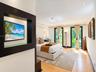 Wood-finish flooring, recessed ceiling lighting, and dual glass-paneled exterior doors with dark-toned frames