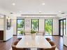 Open-concept interior featuring recessed lighting, a coffered ceiling, wood-finish flooring, and floor-to-ceiling glass panel doors