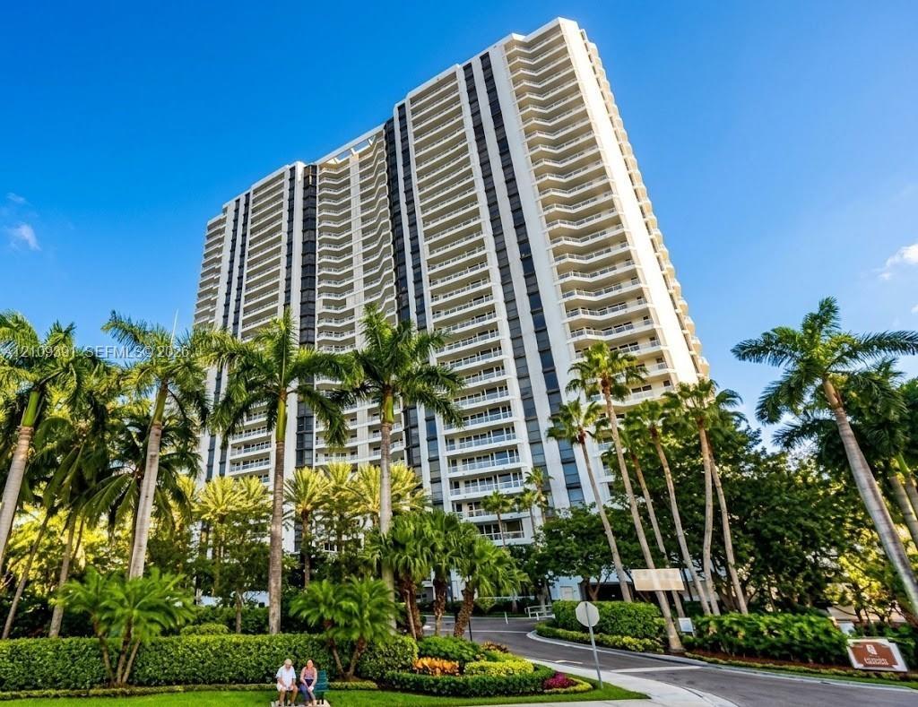 Aerial coastal perspective featuring high-rise towers, private marina slips, and proximity to the open ocean
